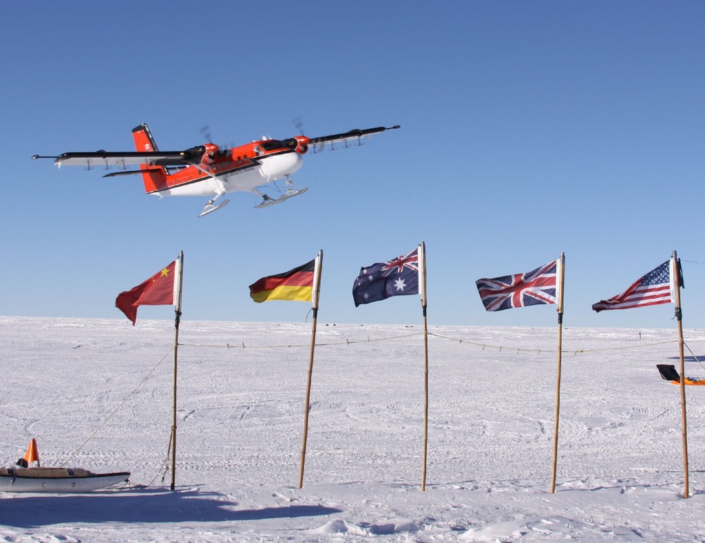 US twin otter over flags © British Antarctic Survey http://www.antarctica.ac.uk